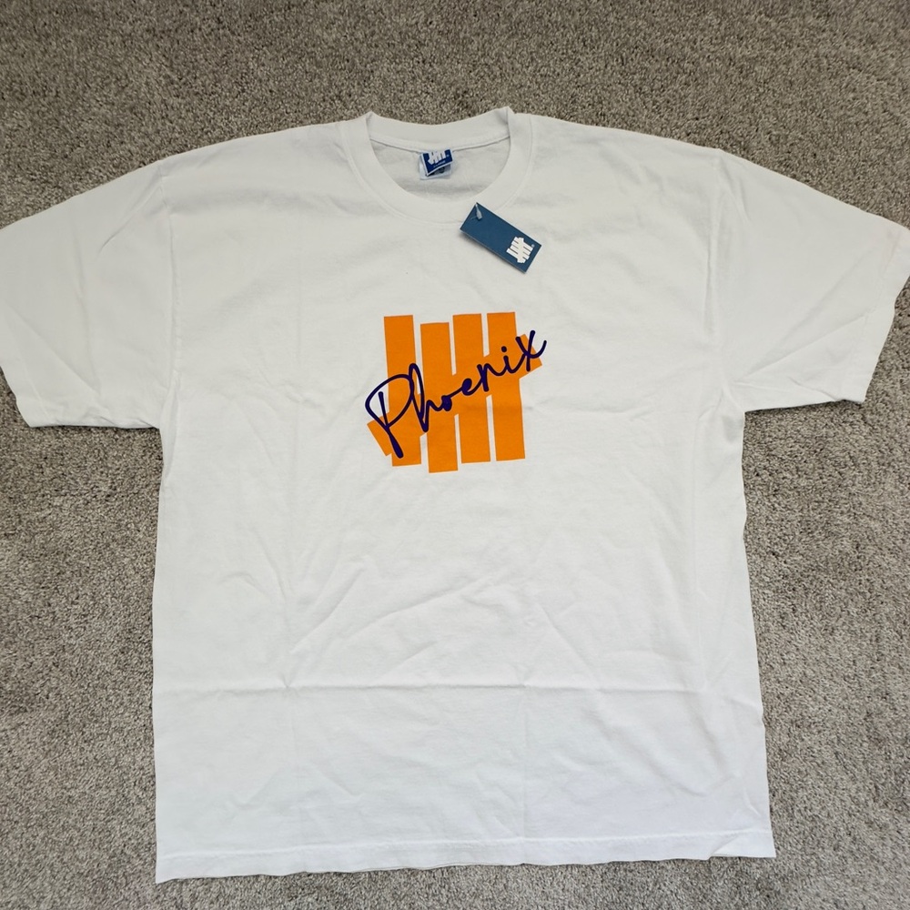 Undefeated White Tee with Orange and Blue Graphic
